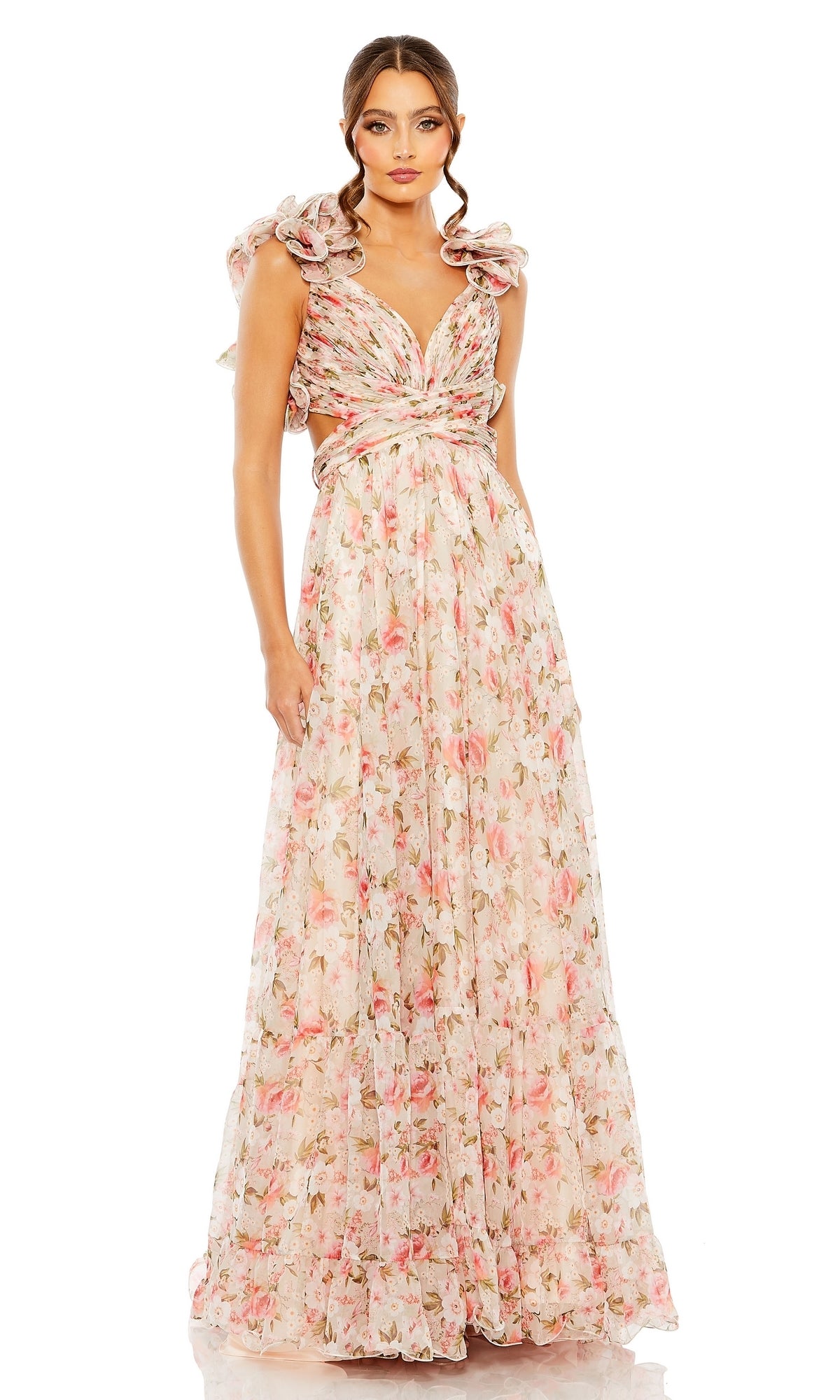 A woman wears the Long Formal Dress 68519 by Mac Duggal—a pastel floral, floor-length A-line gown with ruffled shoulders and a deep V-neckline—standing against a white background.